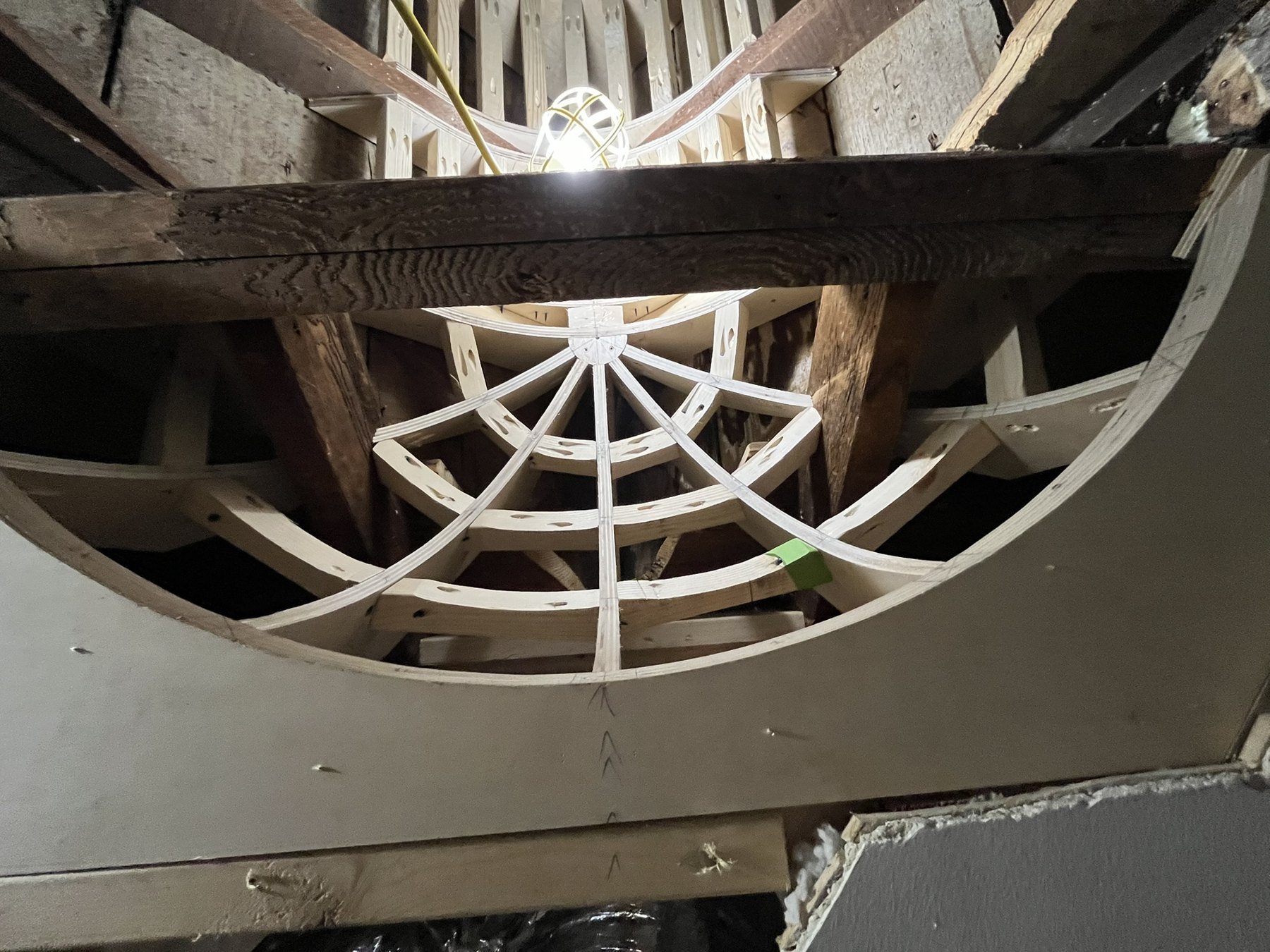 Curved framing ribs fitted between retained dark timber members