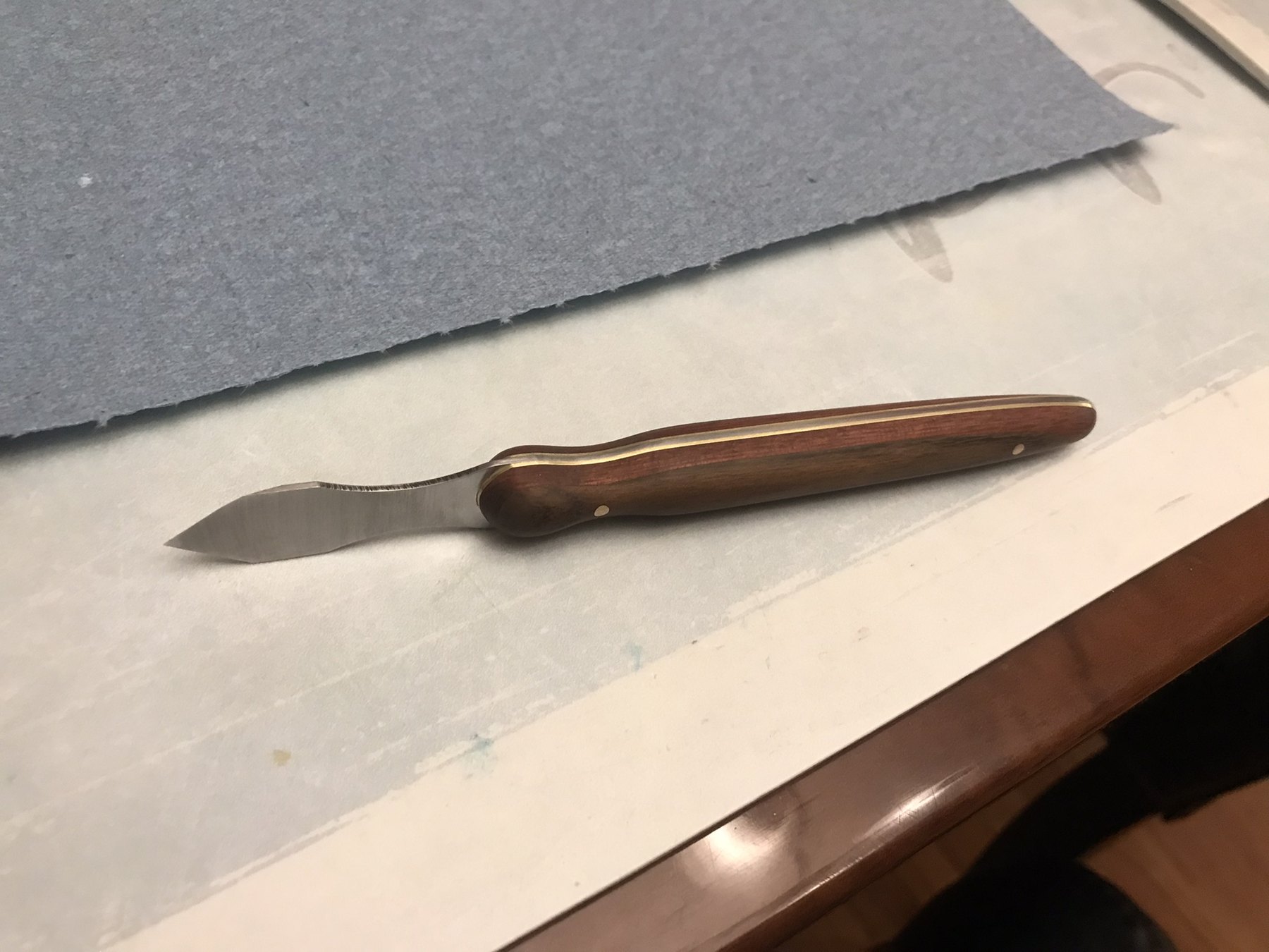Wood-handled marking knife resting on a work surface