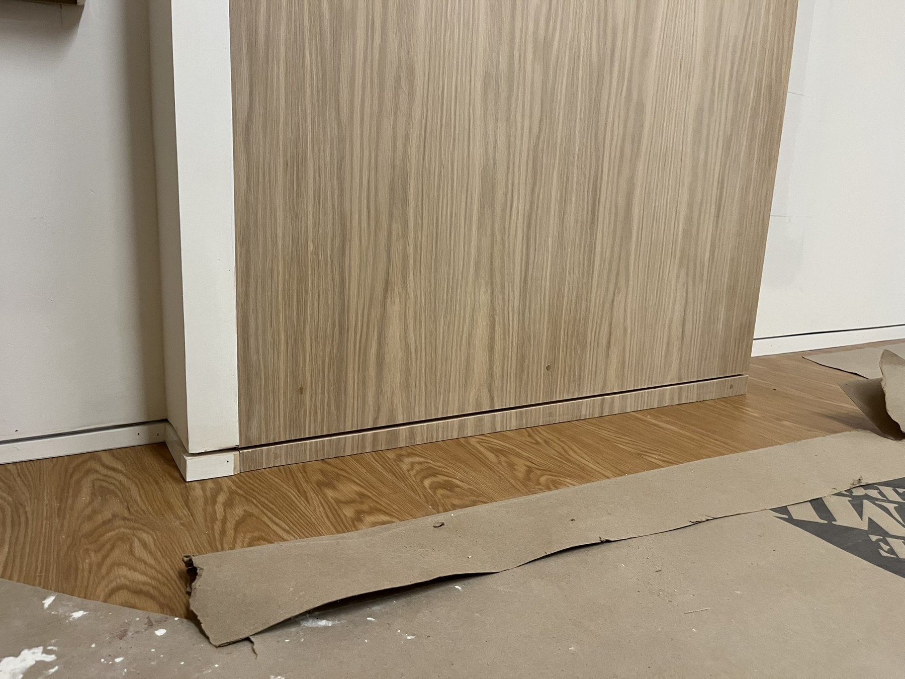 Flush oak door panel meeting the wood floor