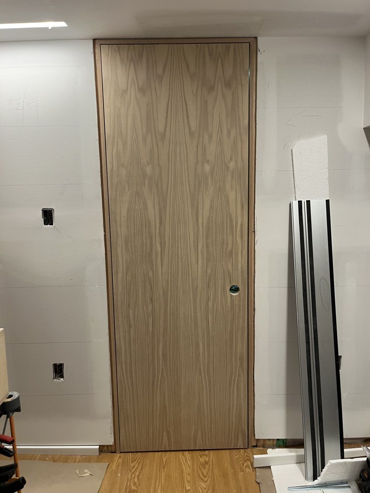 Full-height oak veneered door with centered grain in its fitted frame