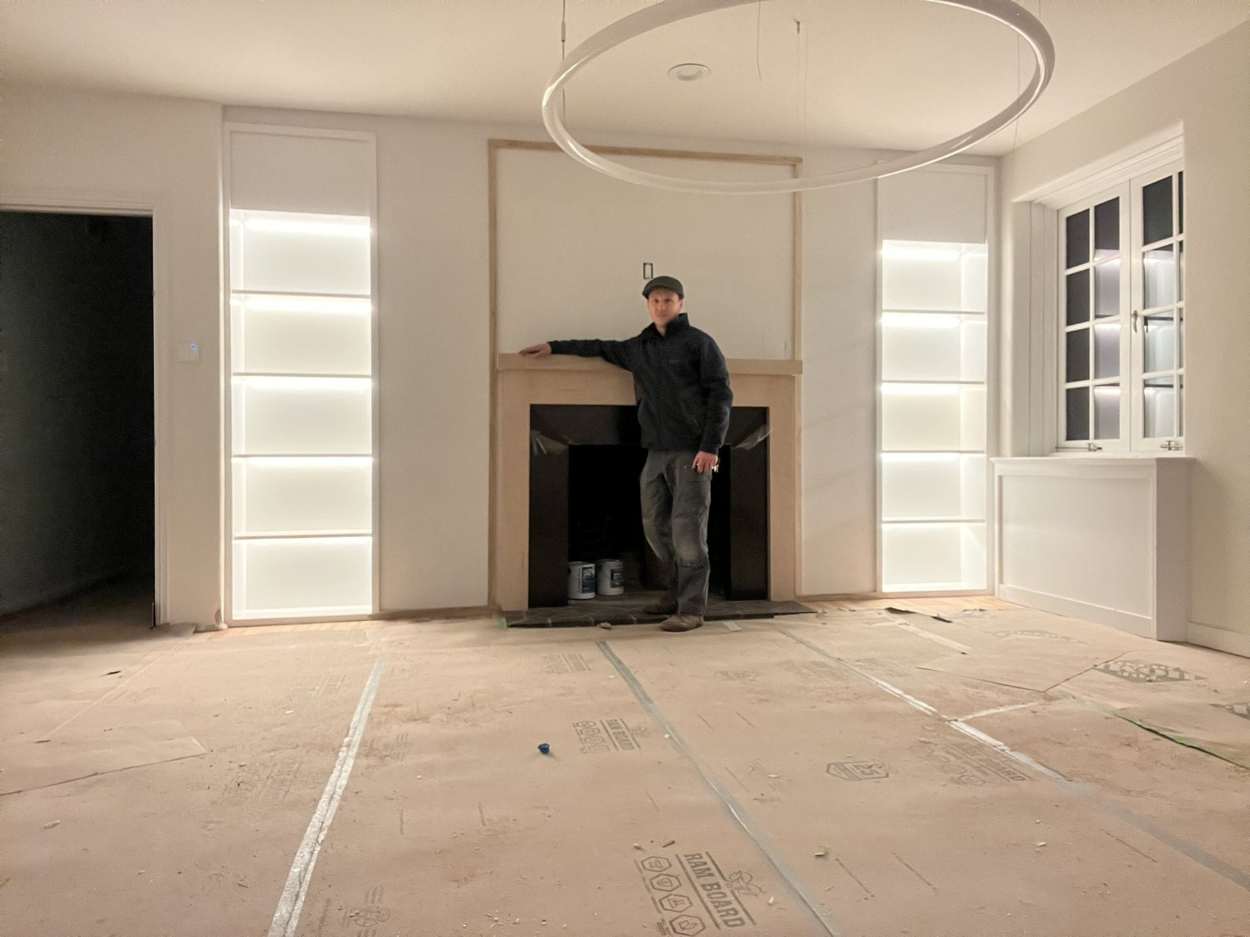Installation view beside the upstairs mantel and illuminated built-in shelves