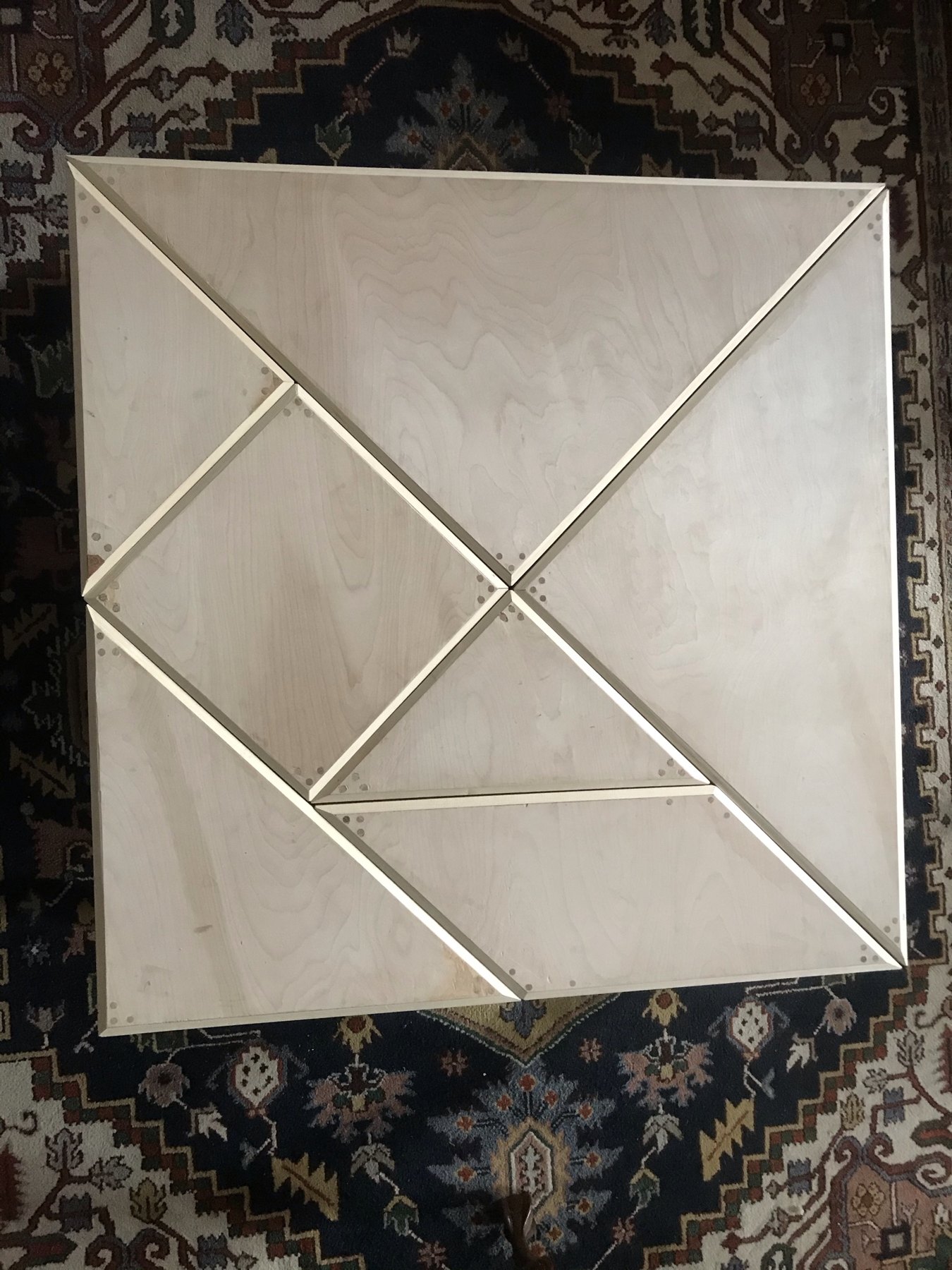 Unfinished geometric table pieces arranged together